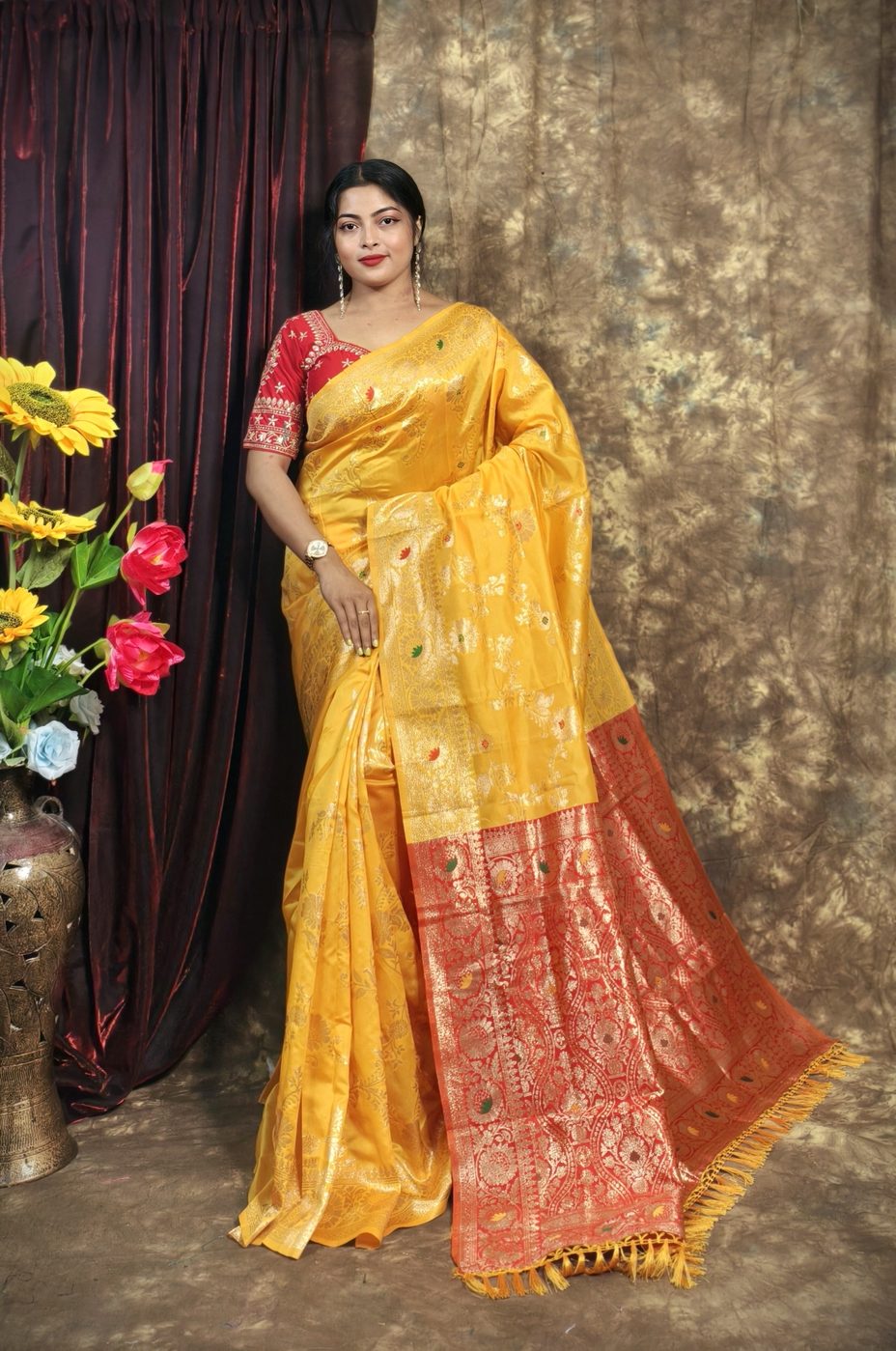 Model wearing a golden yellow Banarasi silk saree